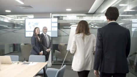 Smiling-business-people-shaking-hands-in-office